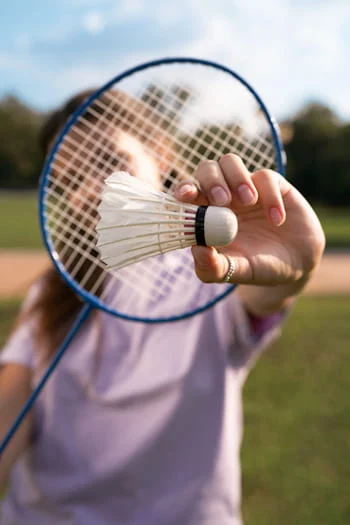 A woman holding a racket, front view